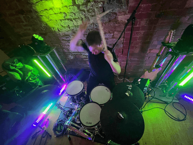 Wedding DJ performing at a reception in London with dance floor lighting